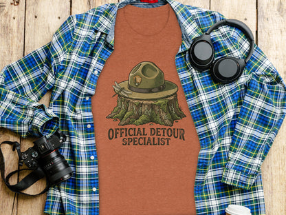 Official Detour Specialist Heritage | Vintage Outdoor Apparel: T-shirt with park ranger hat on stump, "Official Detour Specialist" text.