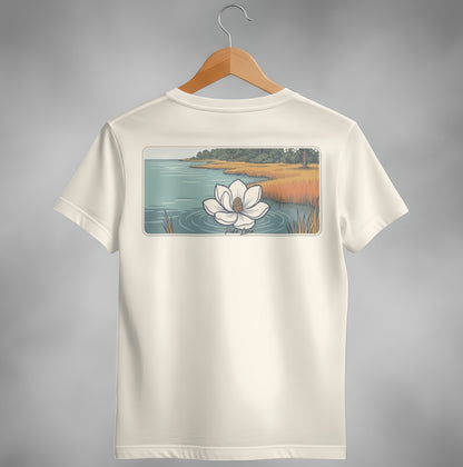 Cream t-shirt with a white magnolia flower on water and marshland scene.