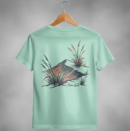 Mint green t-shirt with abstract mountain and grass design and "Puka Luna" text.