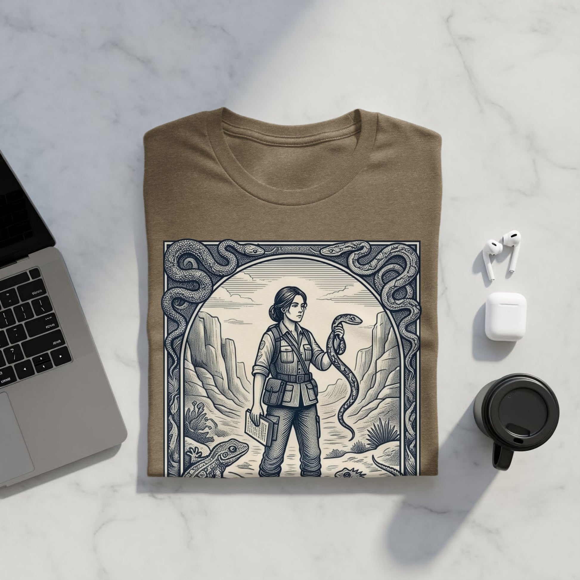T-shirt featuring a woman holding a snake in a desert landscape illustration.