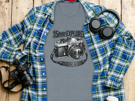 35mm Explorer Detour | Vintage Outdoor Apparel: Gray t-shirt with 35mm camera graphic, "TAKE THE DETOUR" text, laid flat with flannel shirt.