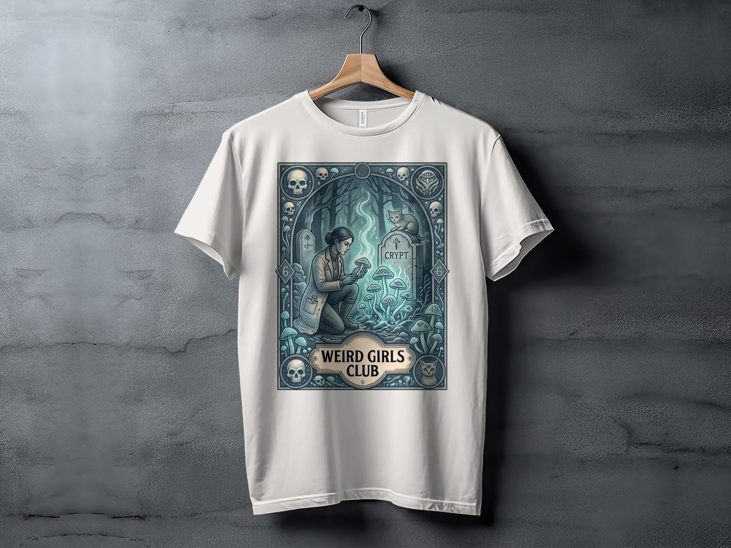 White t-shirt with a circular graphic of a woman in a laboratory coat next to a tombstone and mushrooms.