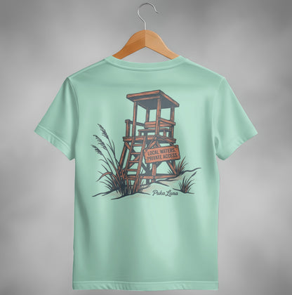 Pale teal t-shirt featuring a wooden lifeguard stand and "Puka Luna" text.