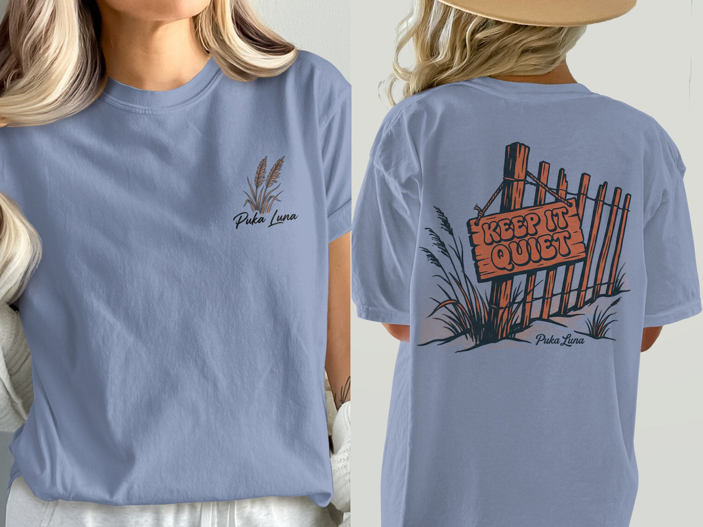 Periwinkle t-shirt with "Puka Luna" text and wheat graphic on front, and fence with "KEEP IT QUIET" sign on back.