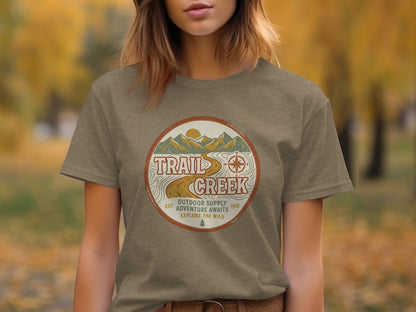 Heritage Heritage Explorer Trail Creek Nomad Tee: Brown t-shirt with "Trail Creek Outdoor Supply Adventure Awaits" circular logo.