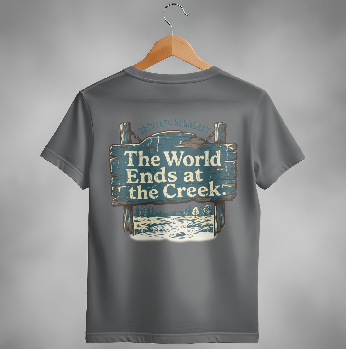 Gray t-shirt with "The World Ends at the Creek" text on wooden sign graphic.