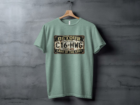 Detour 'Land of the Lost' Vintage | Vintage Outdoor Apparel: Green t-shirt with "Detour Motor Vehicle C16-HWG Land of the Lost Est. 1974" graphic.