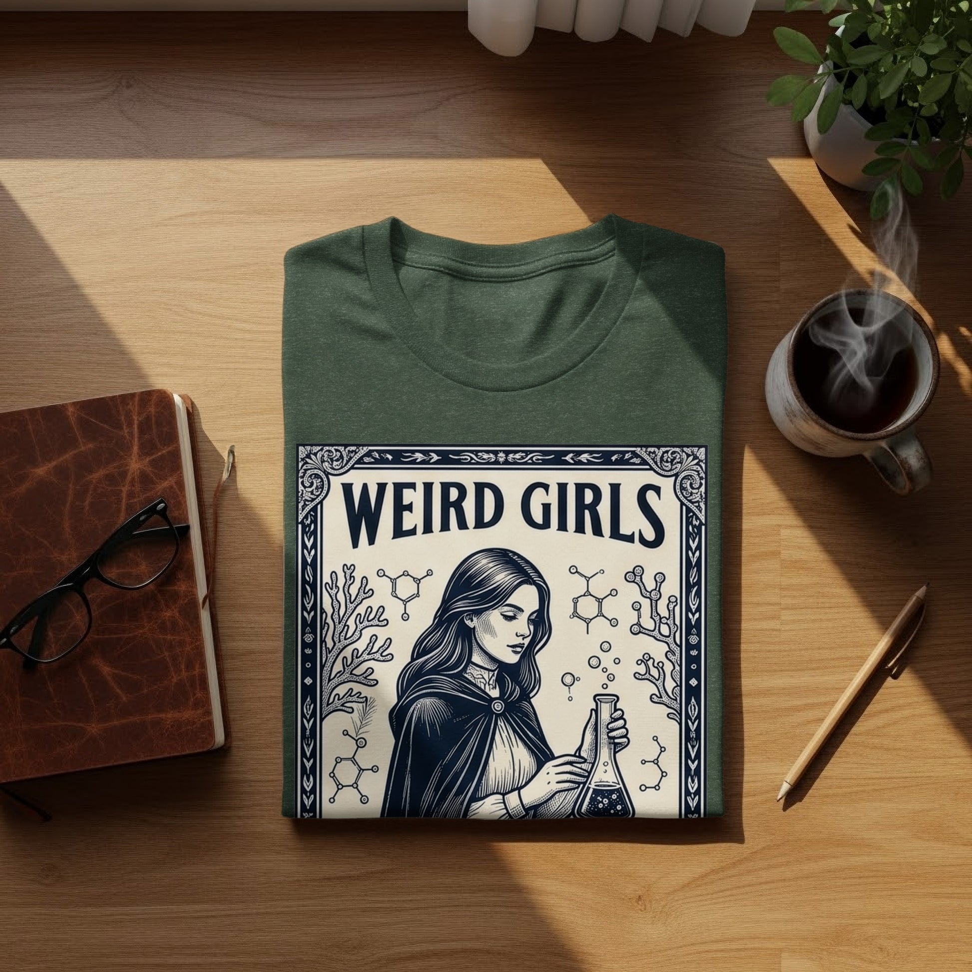 Dark green t-shirt with "Weird Girls" text and illustration of a woman holding a flask.
