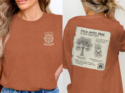 T-shirt with "Take the Detour" on front, "Field Notes" swamp survey with palm and orchid on back.