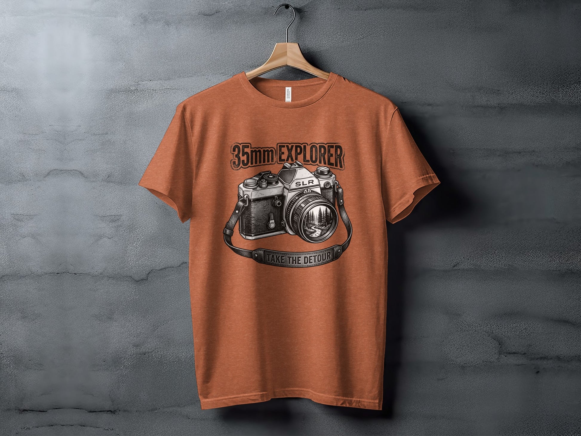 35mm Explorer Detour | Vintage Outdoor Apparel: Orange t-shirt with a vintage SLR camera graphic and "35mm EXPLORER" text.