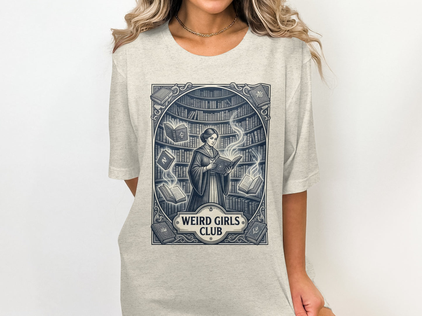 T-shirt graphic of a woman reading surrounded by bookshelves and glowing books.