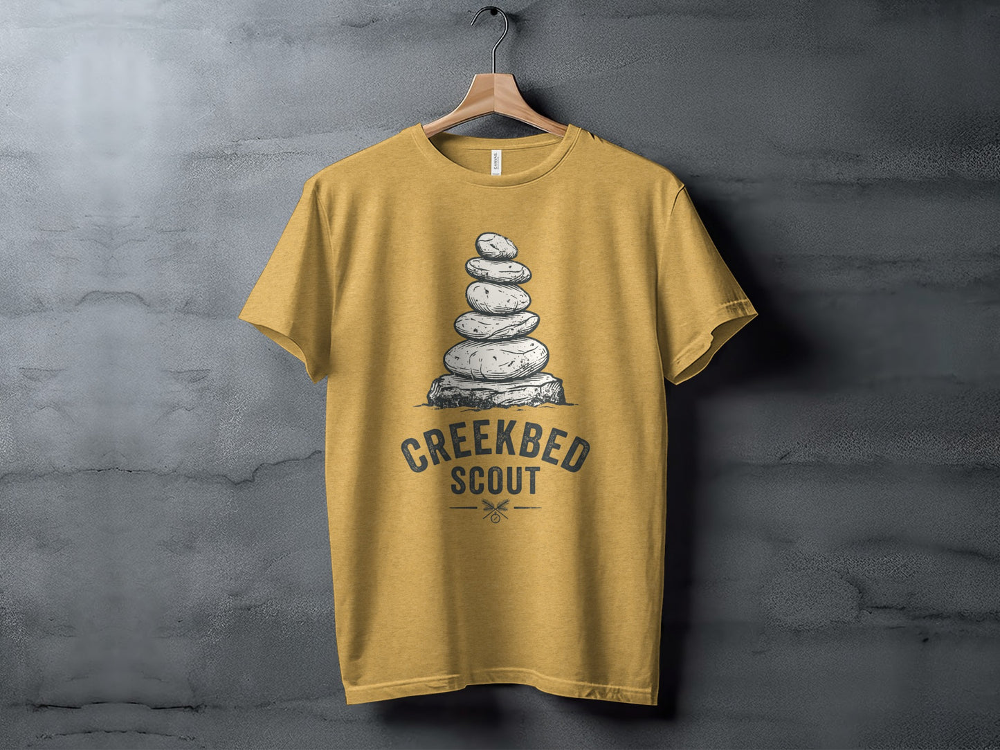 Creekbed Scout Cairn Graphic: The Explorer's Adventure Tee: Yellow t-shirt with stacked stones and "Creekbed Scout" text design.