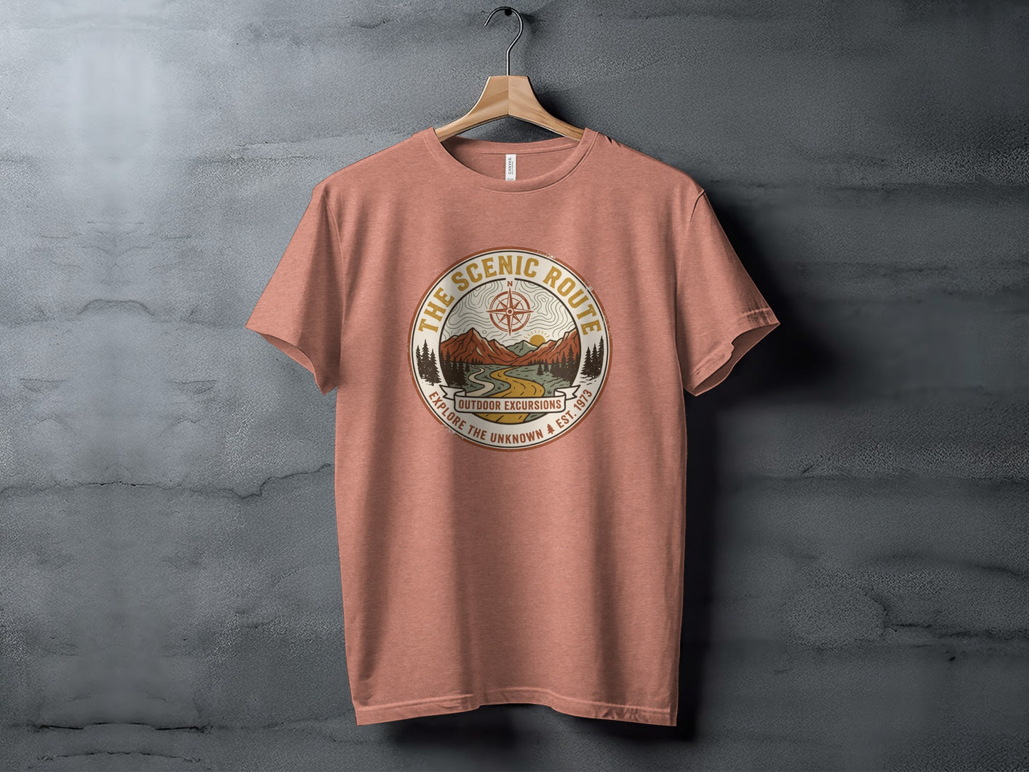 Heritage Scenic Route Vintage Explorer Tee Nomad Tee: Peach t-shirt with "The Scenic Route Outdoor Excursions" graphic featuring mountains.