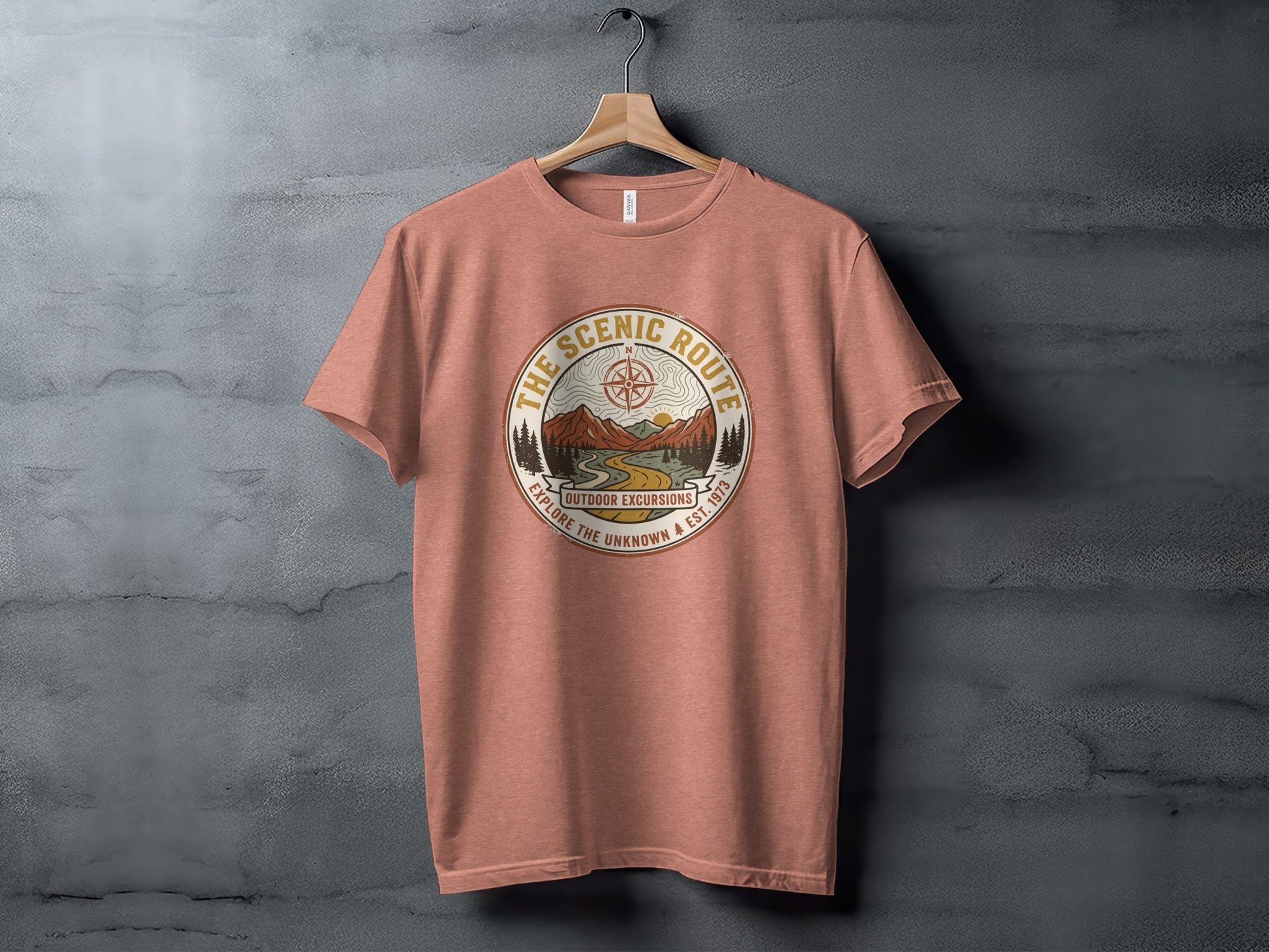 Heritage Scenic Route Vintage Explorer Tee Nomad Tee: Peach t-shirt with "The Scenic Route Outdoor Excursions" graphic featuring mountains.