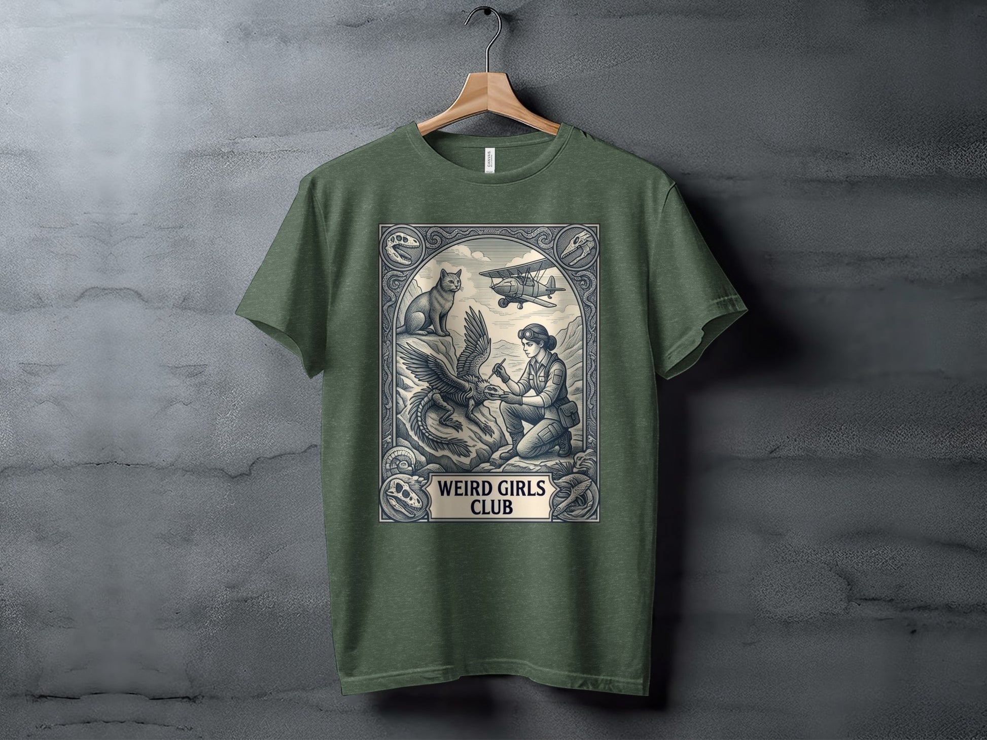 T-shirt graphic: Woman with eagle and biplane, "Weird Girls Club" text.