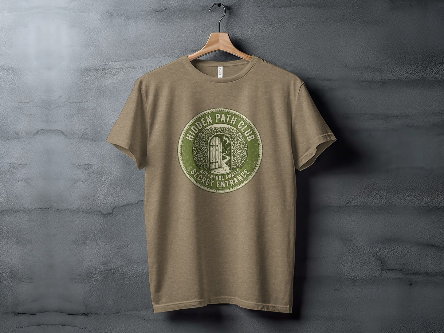 Hidden Path Club: Secret Entrance | Vintage Outdoor Apparel: Green circular logo on a taupe t-shirt reading "Hidden Path Club" and "Adventure Awaits Secret Entrance."