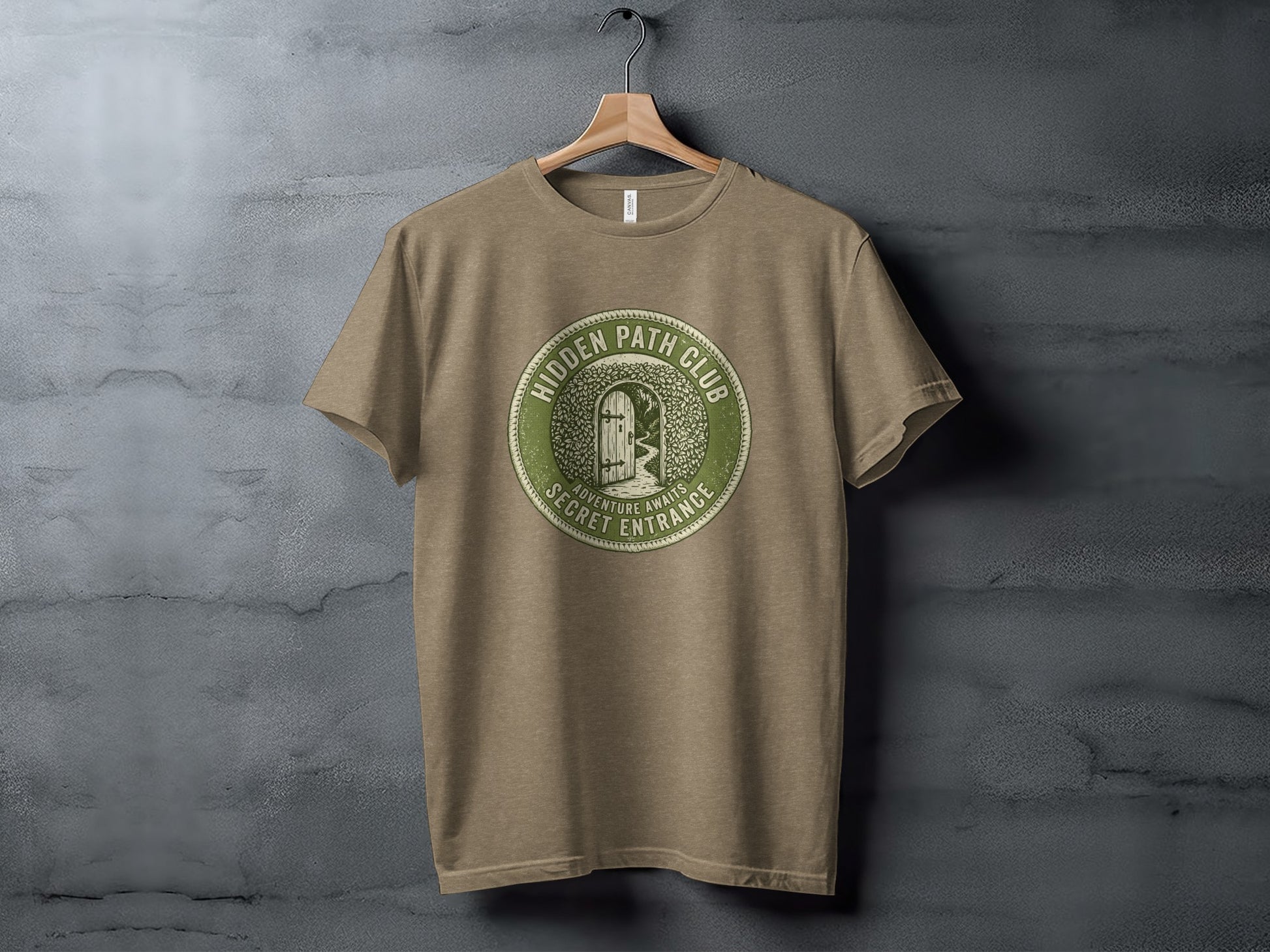 Hidden Path Club: Secret Entrance | Vintage Outdoor Apparel: Green circular logo on a taupe t-shirt reading "Hidden Path Club" and "Adventure Awaits Secret Entrance."