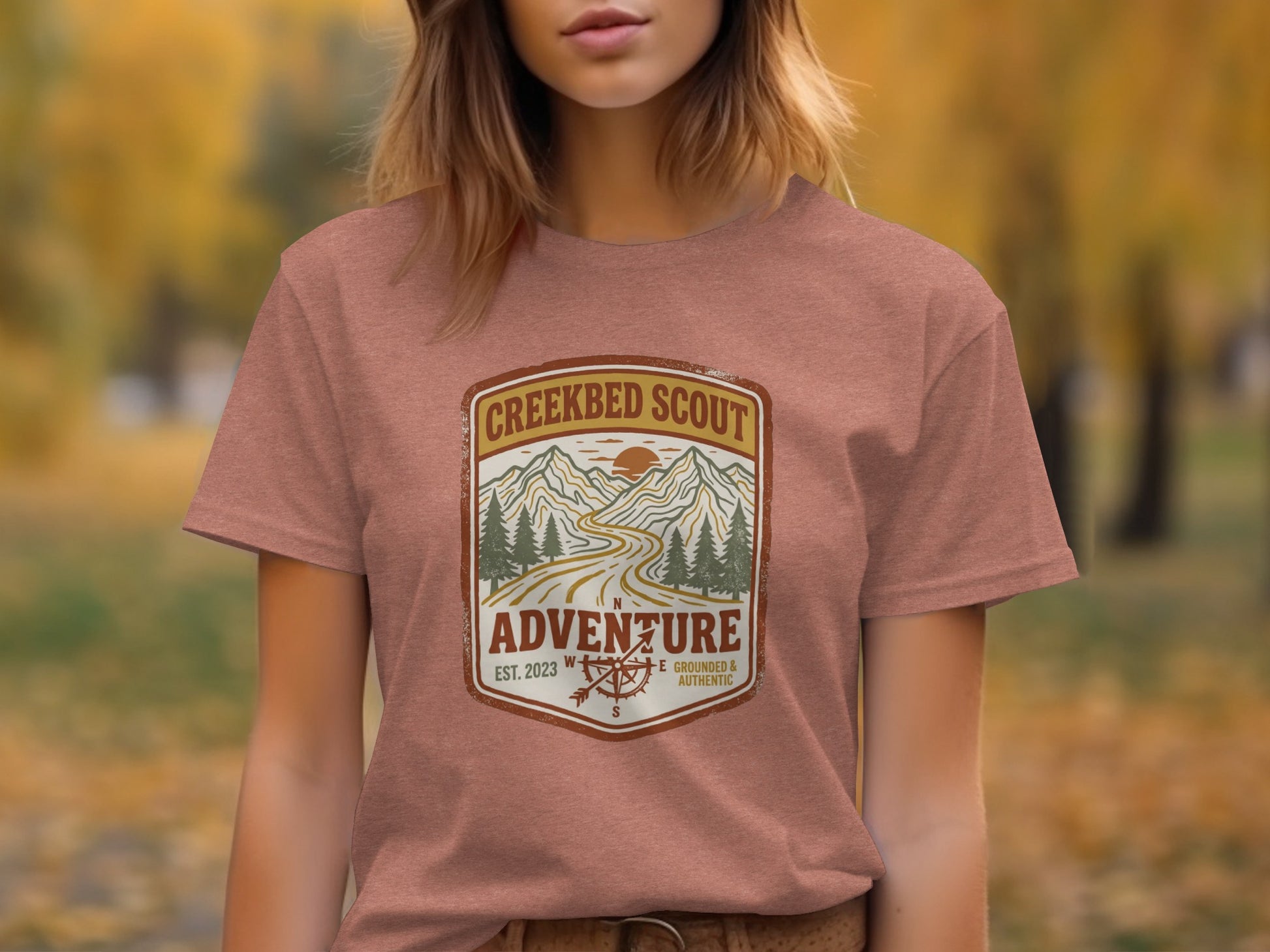 Rugged Creekbed Scout Adventure Emblem Wilderness Shirt: Creekbed Scout Adventure t-shirt with mountains and compass design.