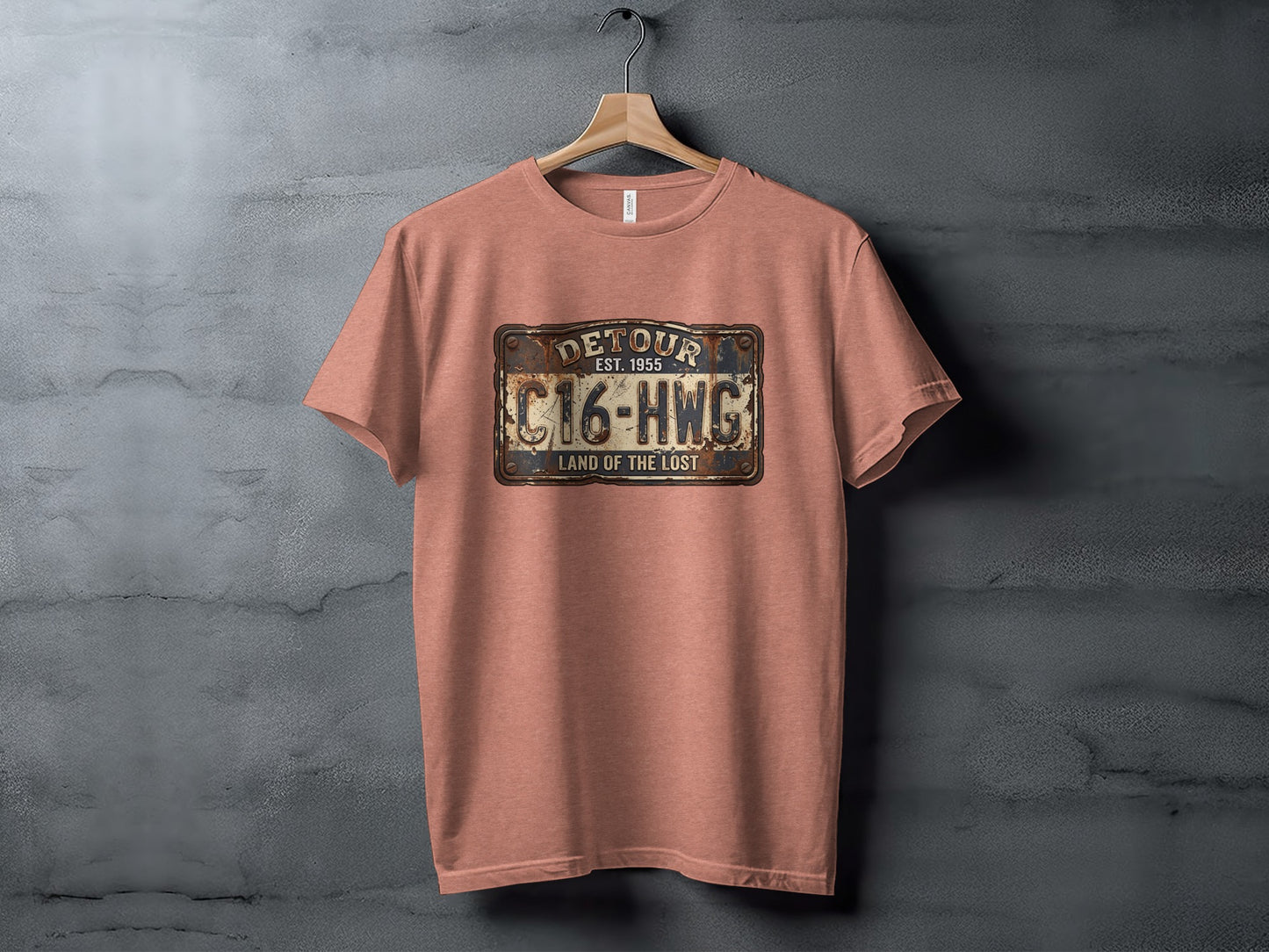 Land of the Lost Detour Plate: The Explorer's Adventure Tee: Rust-colored t-shirt with a distressed license plate graphic reading "DETOUR EST. 1955 C16-HWG LAND OF THE LOST".