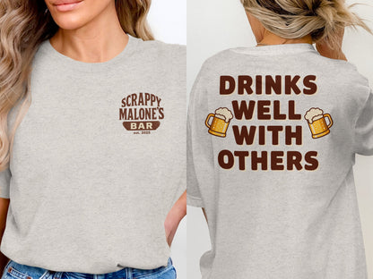 Drinks Well With Others Funny Party Social Graphic T-Shirt T-shirt - Scrappy Malone's Bar 100-Proof Humor - Cloud 16 Clothing Co.