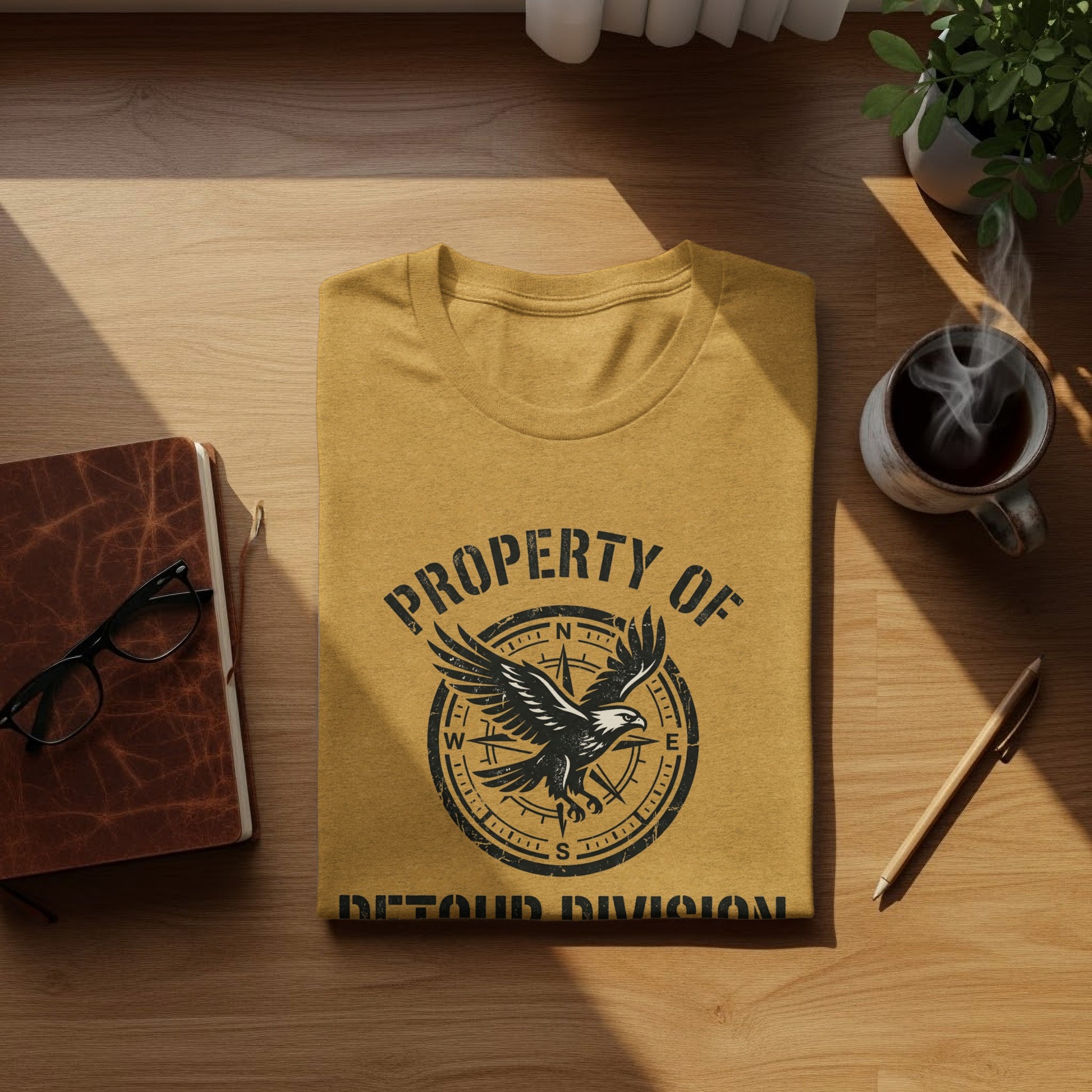 Rugged Detour Division Compass Eagle Tee Wilderness Shirt: Yellow t-shirt with "Property of Detour Division" and eagle graphic.
