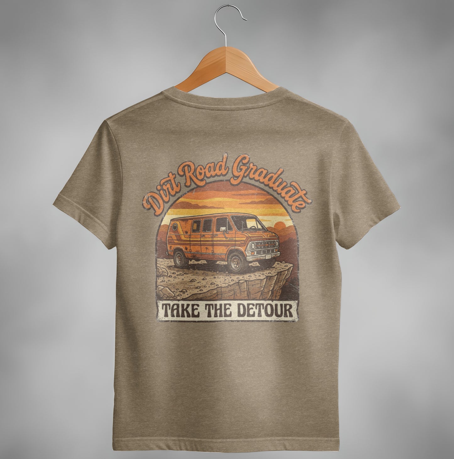 Orange van on a rocky cliff with sunset text: "Dirt Road Graduate TAKE THE DETOUR".