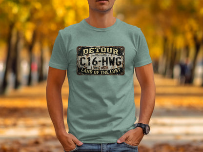 Detour 'Land of the Lost' Vintage | Vintage Outdoor Apparel: Light blue t-shirt with distressed "Detour C16-HWG Land of the Lost" license plate graphic.