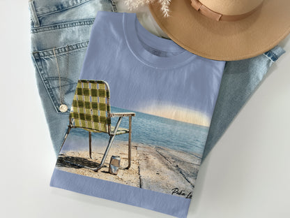 Light blue t-shirt with a beach chair and ocean graphic.