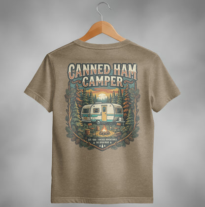 T-shirt graphic of vintage canned ham camper in forest with sunset.
