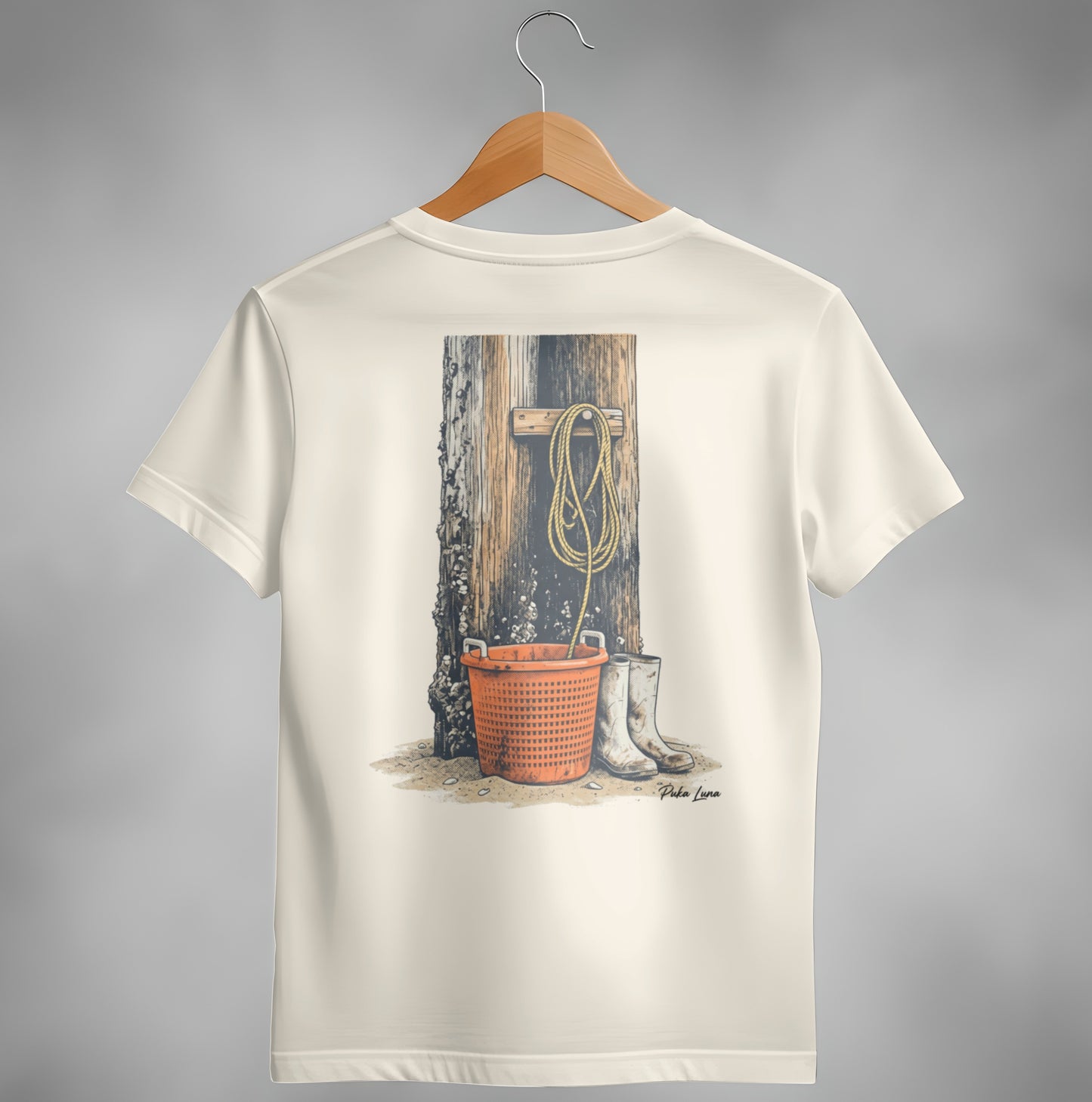 Cream t-shirt with illustration of fishing gear and boots against wooden post.