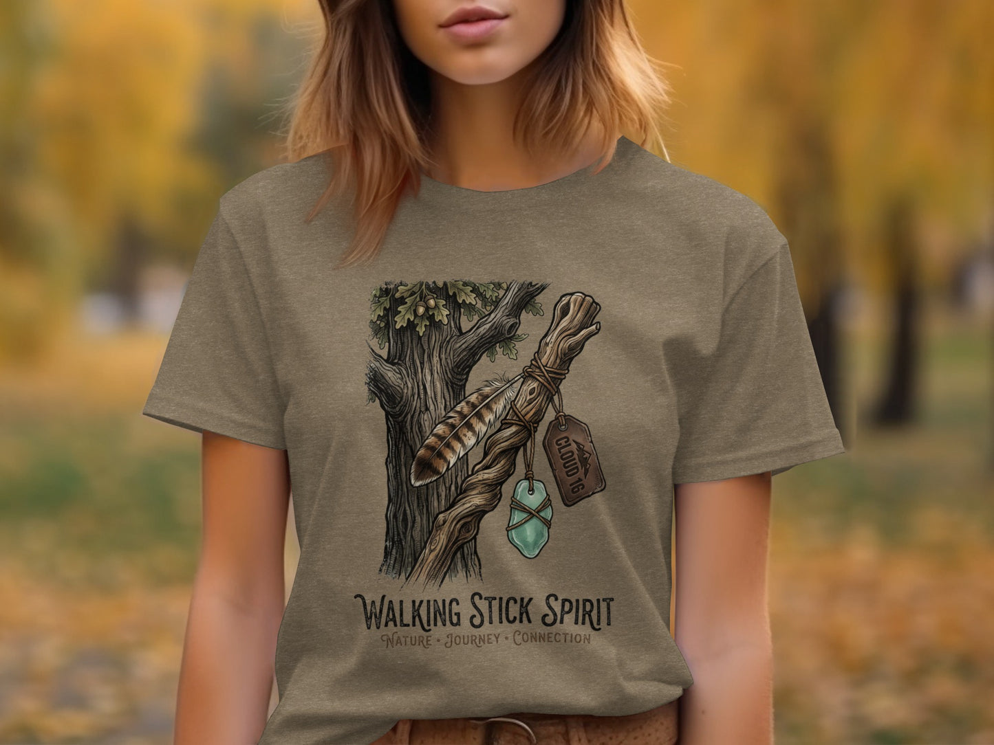 Heritage Walking Stick Spirit: Journey Nomad Tee: T-shirt with illustration of feather, crystal, and tree branch, text "WALKING STICK SPIRIT".