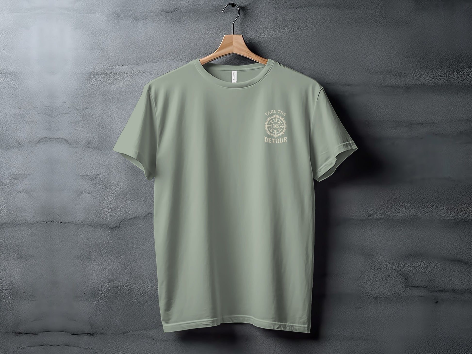 Light green t-shirt with "TAKE THE DETOUR" compass graphic.