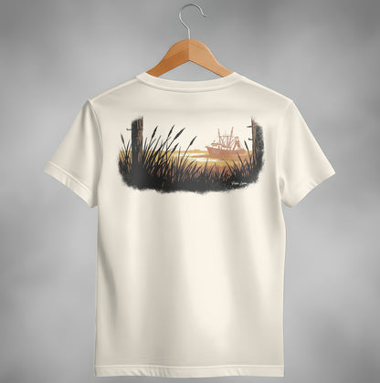 T-shirt back with a painted scene of a fishing boat at sunset behind tall grass.