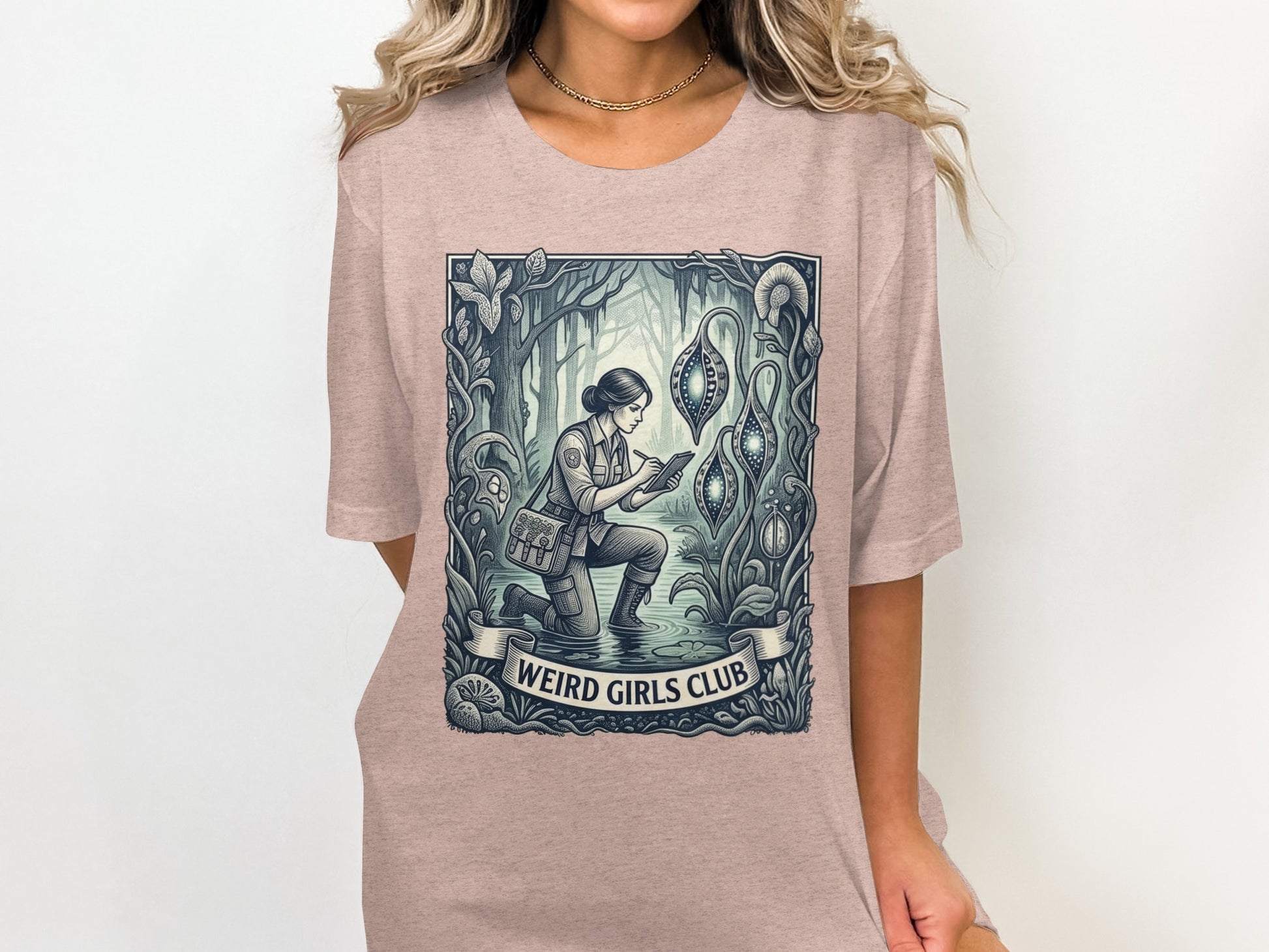 Woman in pink t-shirt with "Weird Girls Club" graphic of woman in botanical illustration.