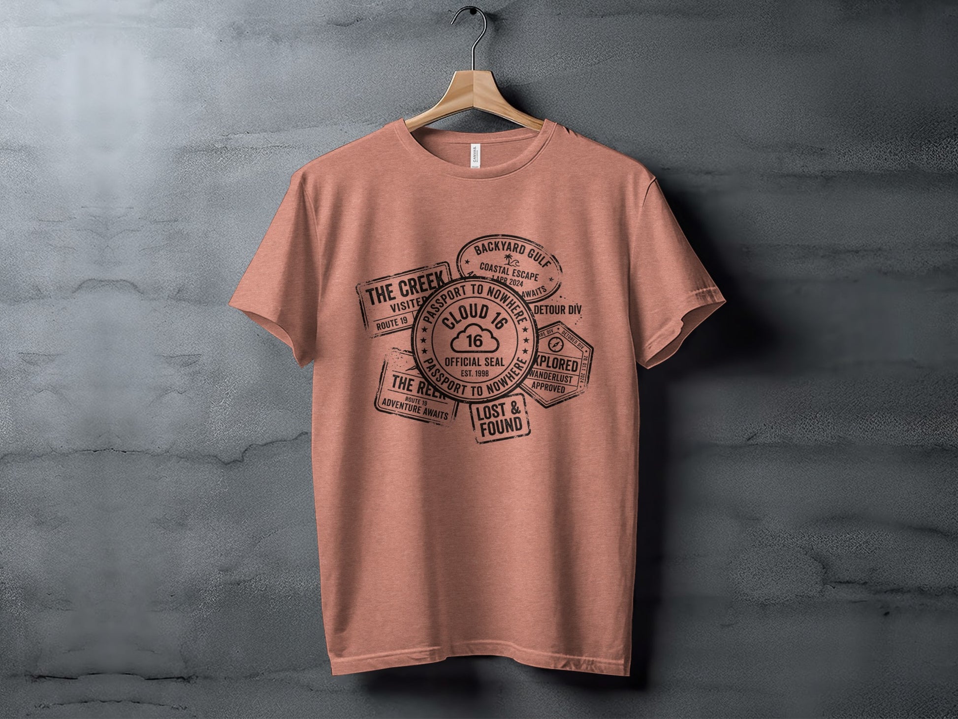 Rugged Wanderlust Passport Stamp Graphic Wilderness Shirt: Coral t-shirt with passport stamp designs and text about "The Creek".
