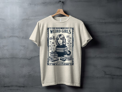 T-shirt graphic with "Weird Girls Club" text, a girl, books, and cassette tapes.