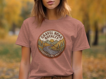 Gravel Road Royalty Vintage Adventure Tee: Backcountry Outpost Shirt: Circular graphic on a dusty rose t-shirt with mountains, road, and "Gravel Road Royalty Adventure Awaits".
