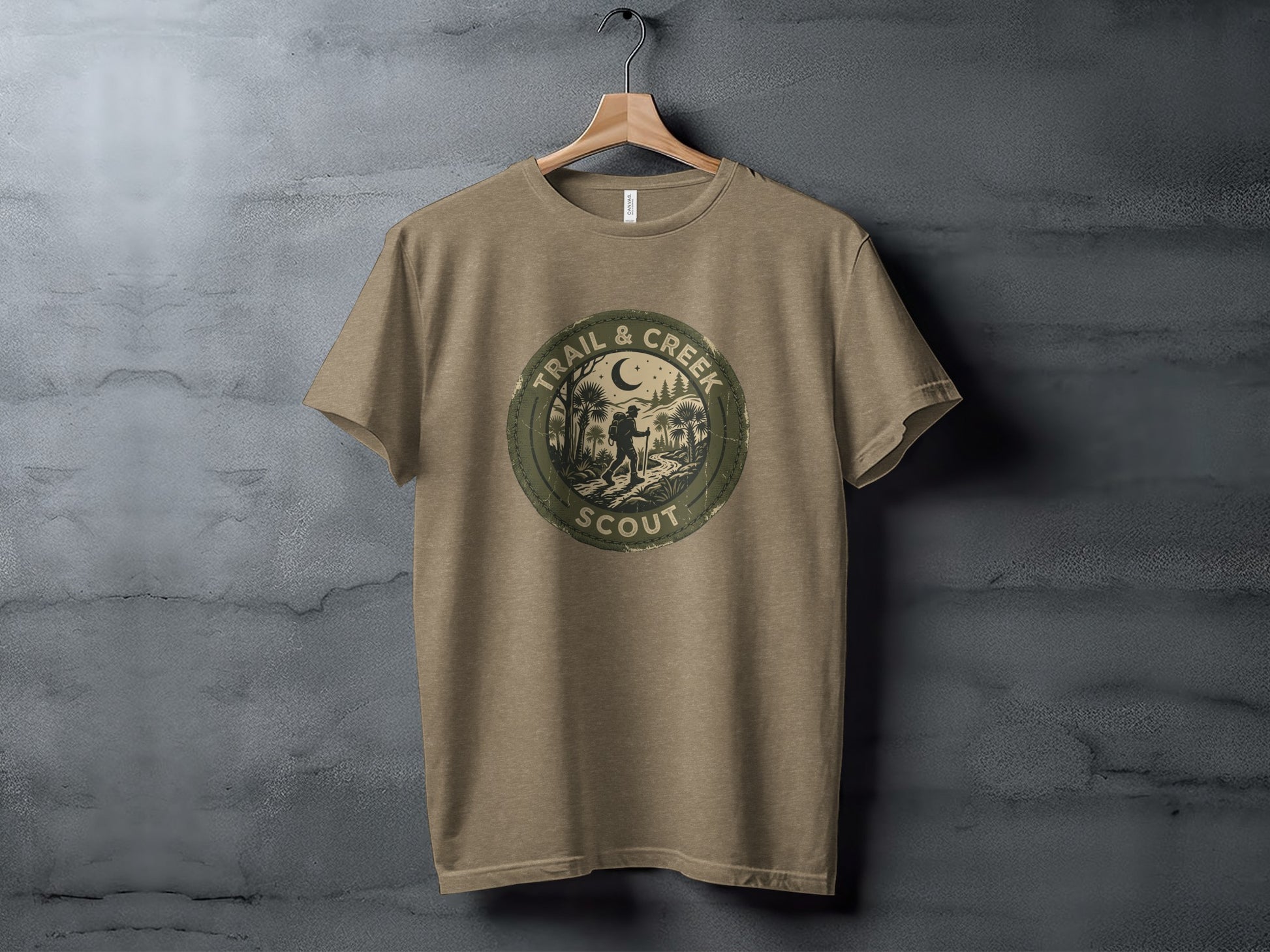 Heritage Trail & Creek Scout Adventure Nomad Tee: Tan t-shirt with round "Trail & Creek Scout" logo featuring a nighttime camping scene.