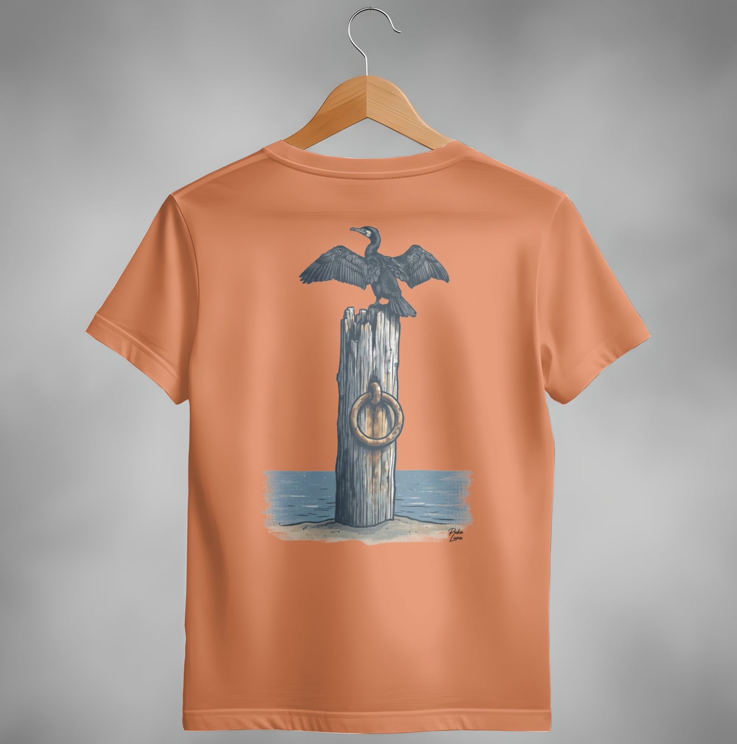 Cormorant perched on a post with a ring, printed on an orange t-shirt.
