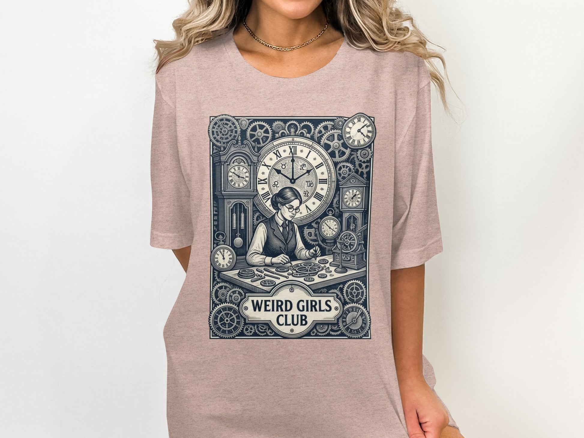 T-shirt graphic of a woman at a desk with gears and clocks, reading "WEIRD GIRLS CLUB".