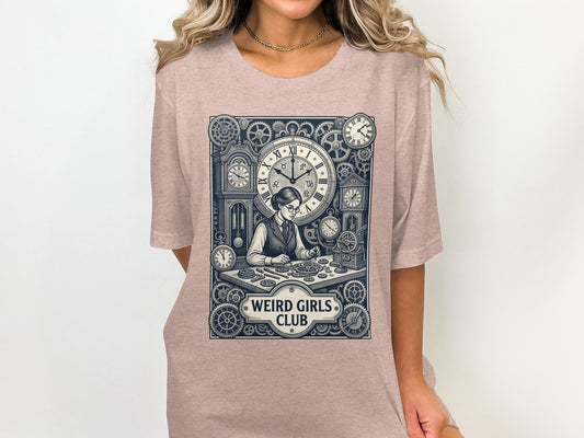 T-shirt graphic of a woman at a desk with gears and clocks, reading "WEIRD GIRLS CLUB".