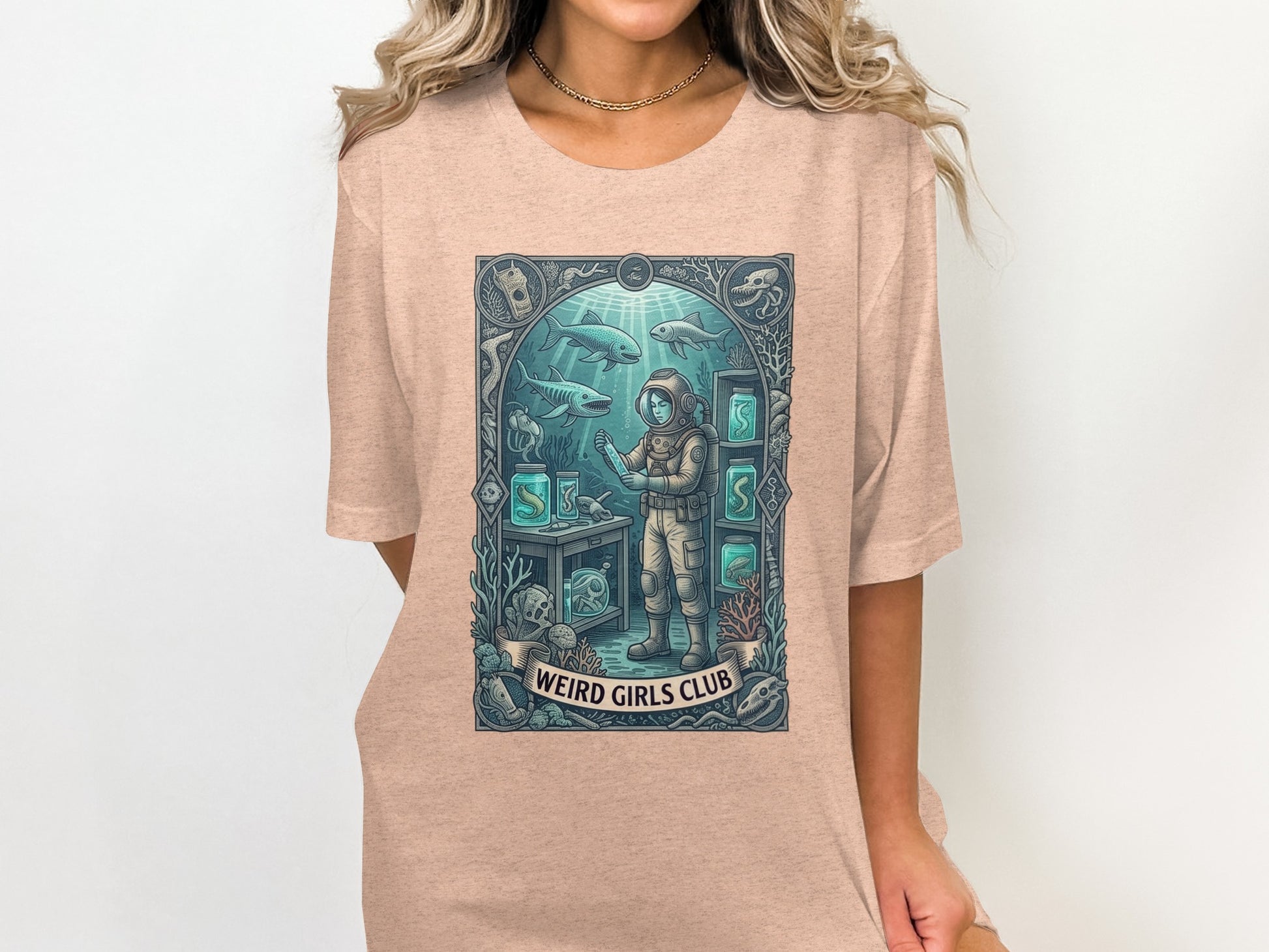 Diver in aquarium surrounded by sea life and text "WEIRD GIRLS CLUB".