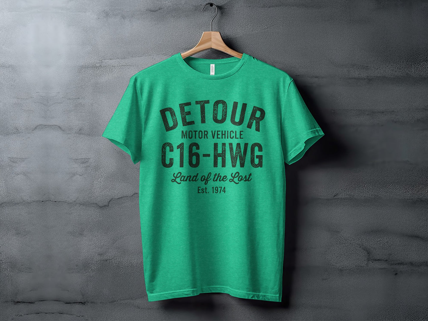 Green t-shirt with "DETOUR MOTOR VEHICLE" and "Land of the Lost" text.