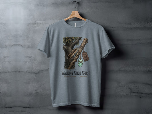 Heritage Walking Stick Spirit: Journey Nomad Tee: Grey t-shirt with a nature-themed design featuring a walking stick and feather.
