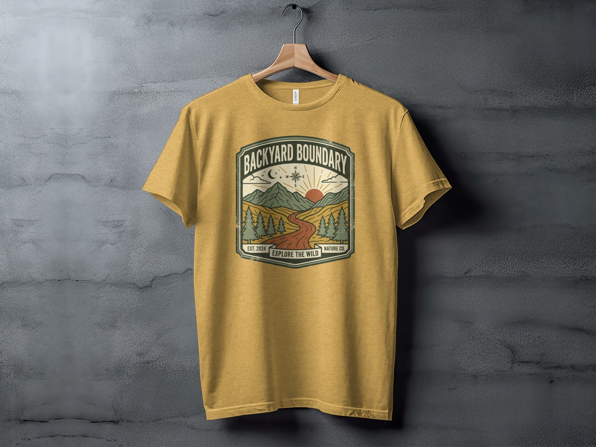 Rugged Backyard Boundary: Explore The Wild Wilderness Shirt: Mustard yellow t-shirt with "Backyard Boundary Nature Co." mountain landscape graphic.