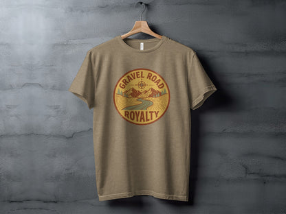 Gravel Road Royalty Adventure Tee | Vintage Outdoor Apparel: Tan t-shirt featuring a circular graphic with "Gravel Road Royalty" text and a mountain landscape.