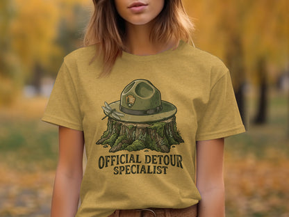 Official Detour Specialist Heritage | Vintage Outdoor Apparel: Ranger hat on tree stump with dragonfly, "OFFICIAL DETOUR SPECIALIST" text.