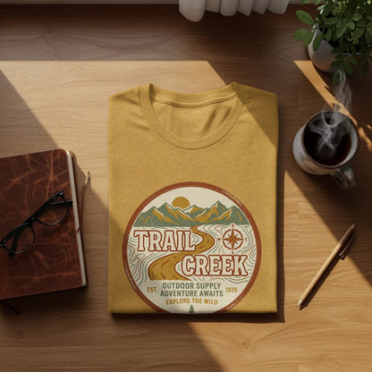 Heritage Heritage Explorer Trail Creek Nomad Tee: Yellow t-shirt with "Trail Creek Outdoor Supply" circular logo and compass.