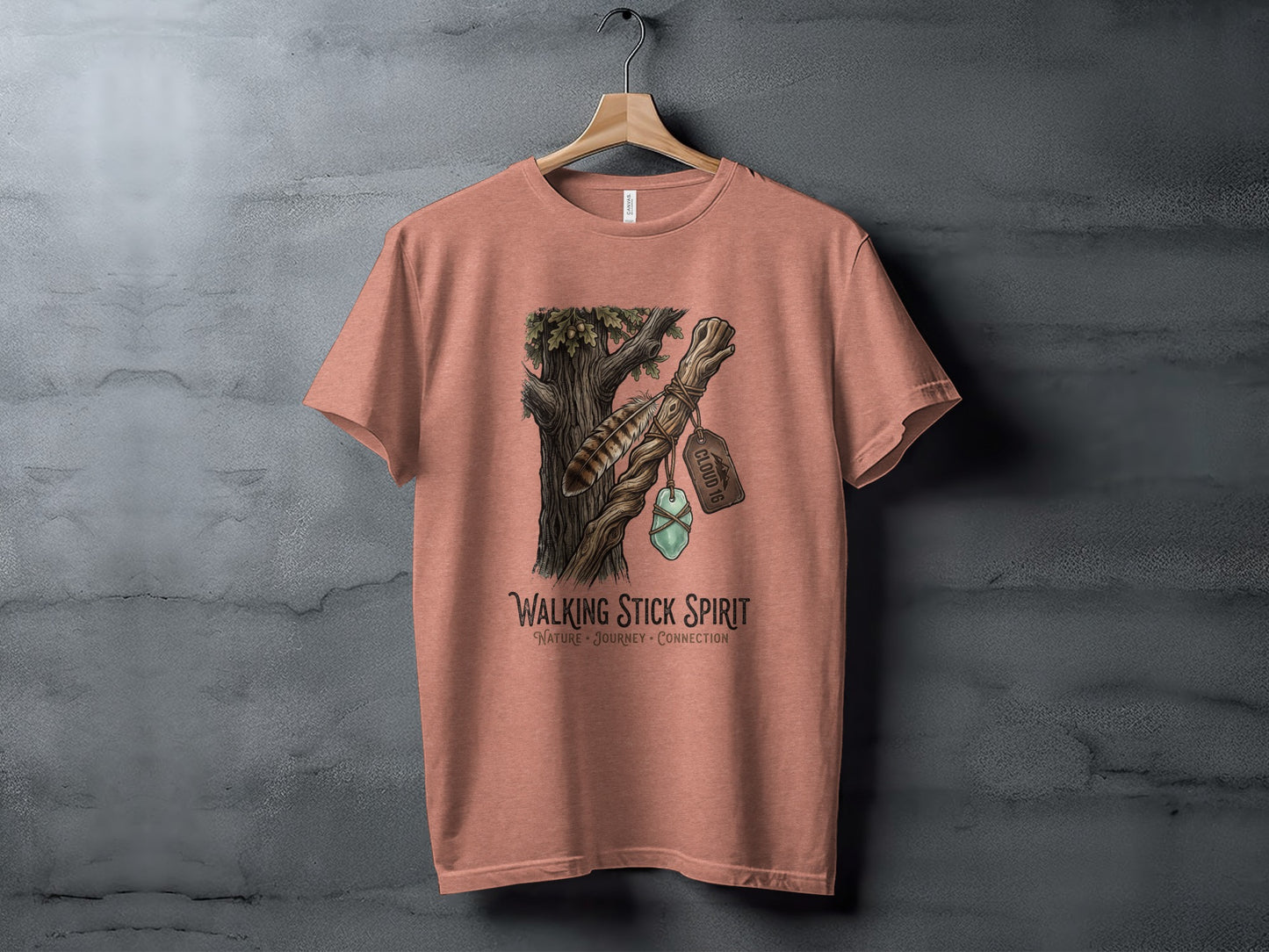Heritage Walking Stick Spirit: Journey Nomad Tee: Peach t-shirt with "Cloud 9" label on a tree branch graphic.