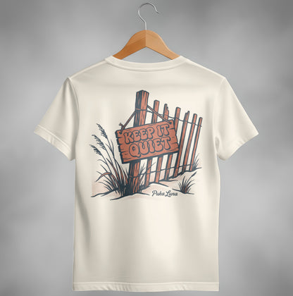 Cream t-shirt with "KEEP IT QUIET" sign on a wooden fence illustration.